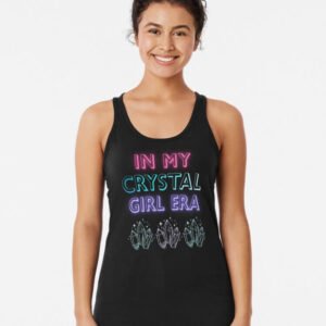 Woman wearing black racerback tank that reads ‘In My Crystal Girl Era’ in neon letters with crystal illustrations along the bottom.