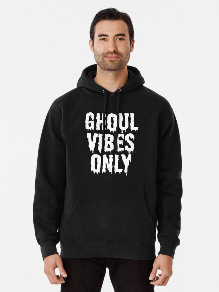 Person wearing a black ‘Ghoul Vibes Only’ hoodie with white dripping gothic lettering