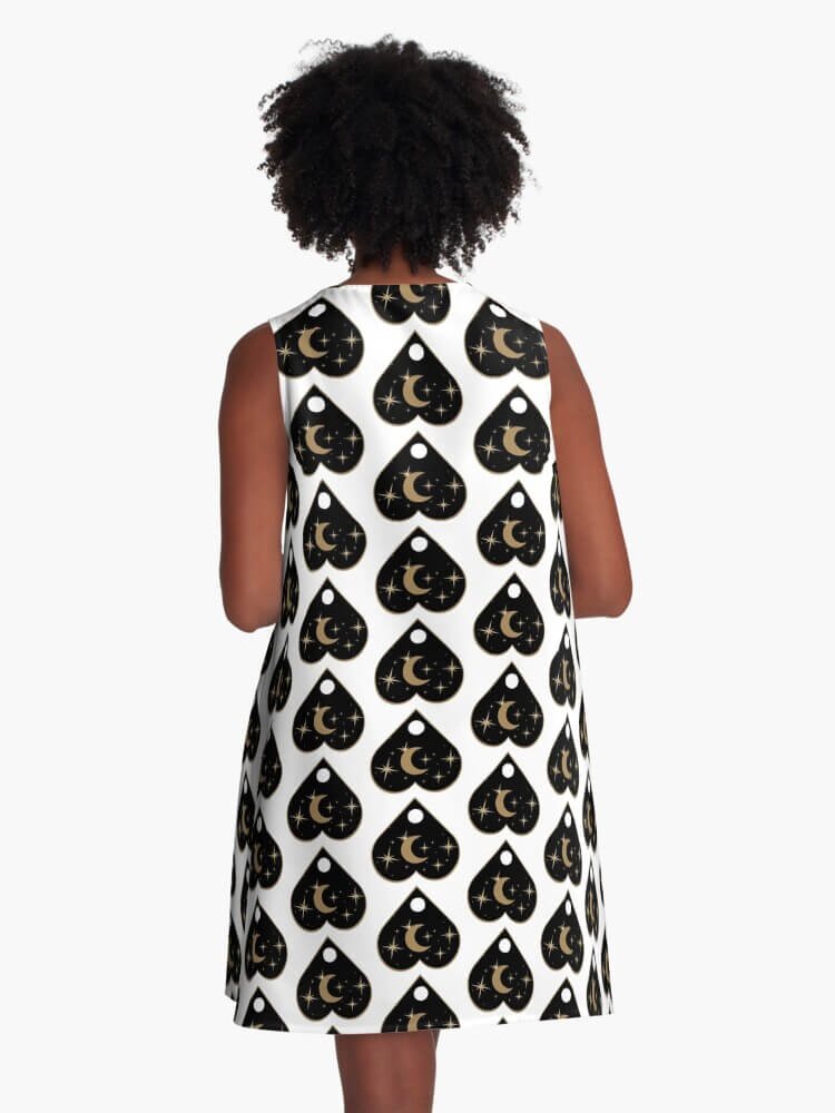 Back view of A-line dress with full golden planchette and crescent moon pattern on white background