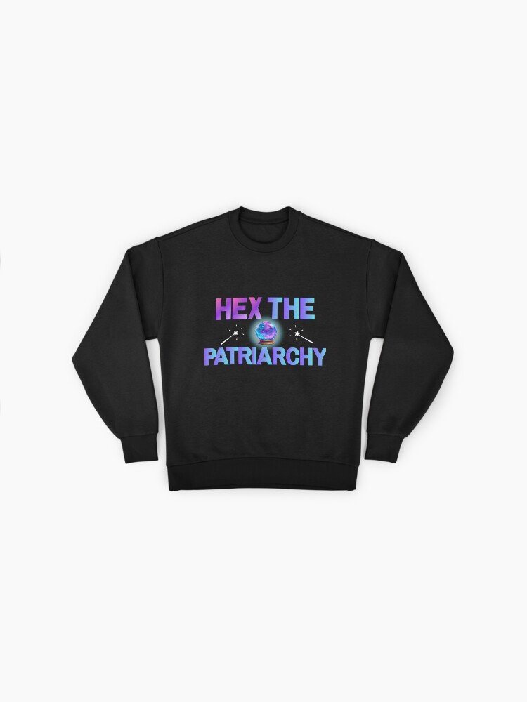oversized sweatshirt with the phrase ‘Hex The Patriarchy’ in gradient pastel lettering and a glowing crystal ball with two magic wands