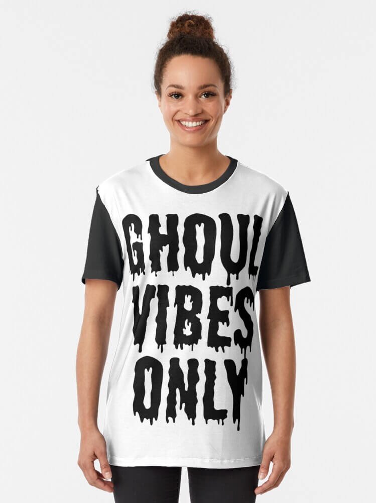 Person smiling while wearing a ‘Ghoul Vibes Only’ Halloween aesthetic graphic tee in black and white
