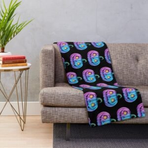 Pastel pumpkin glow throw blanket draped over a grey sofa in a cozy living room