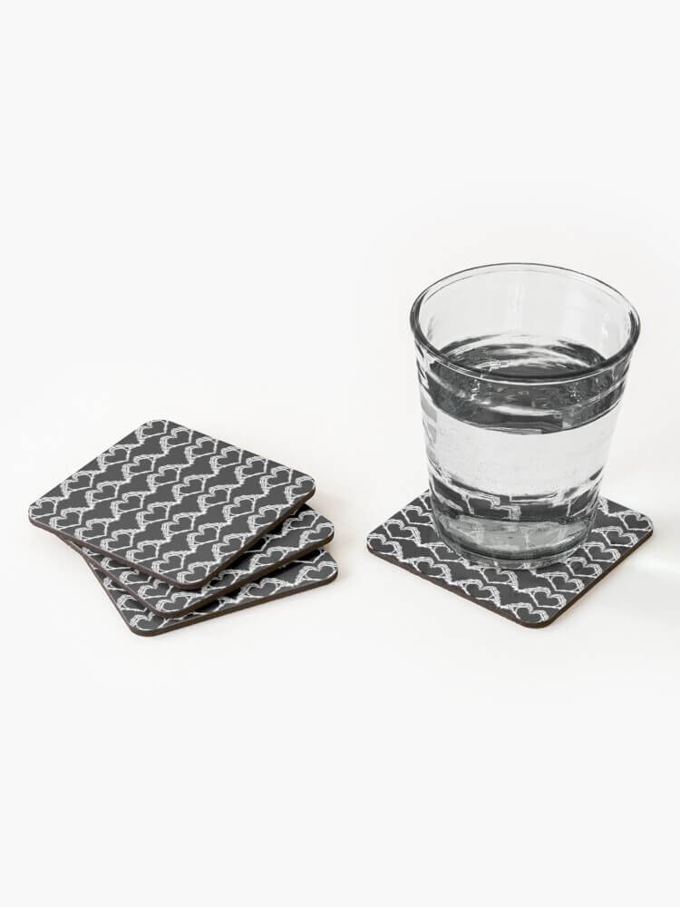 Skeleton love affair coaster set with a drinking glass resting on one coaster and three stacked beside it