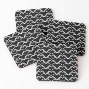 Set of four square coasters with repeating white skeleton-hand heart pattern on a black background